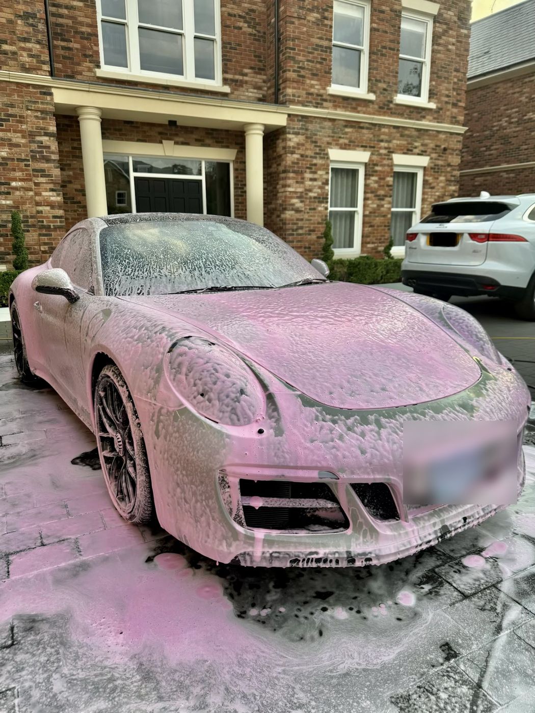 Porsche 911 covered in pink snow foam